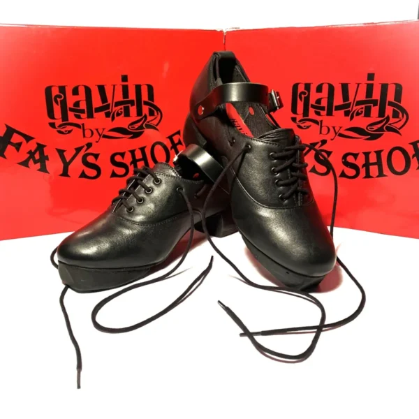 A pair of Gavin By Fays Black shoes with laces in front of a box.