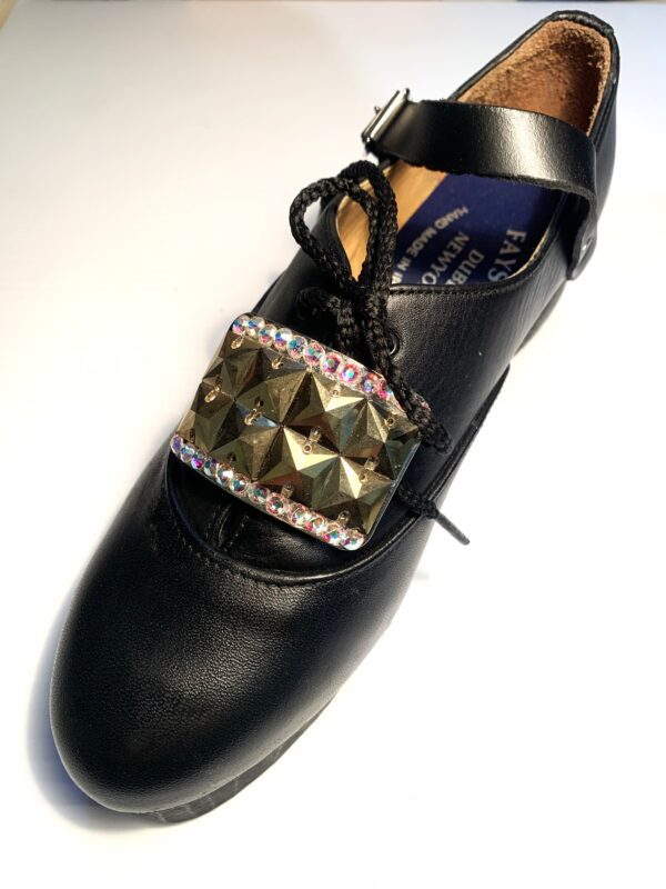 A pair of black shoes with a Mini 8 Square Diamante Buckle.