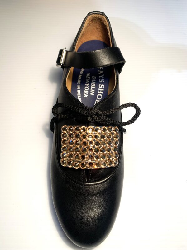 A pair of black shoes with Gold Crystals Buckles.