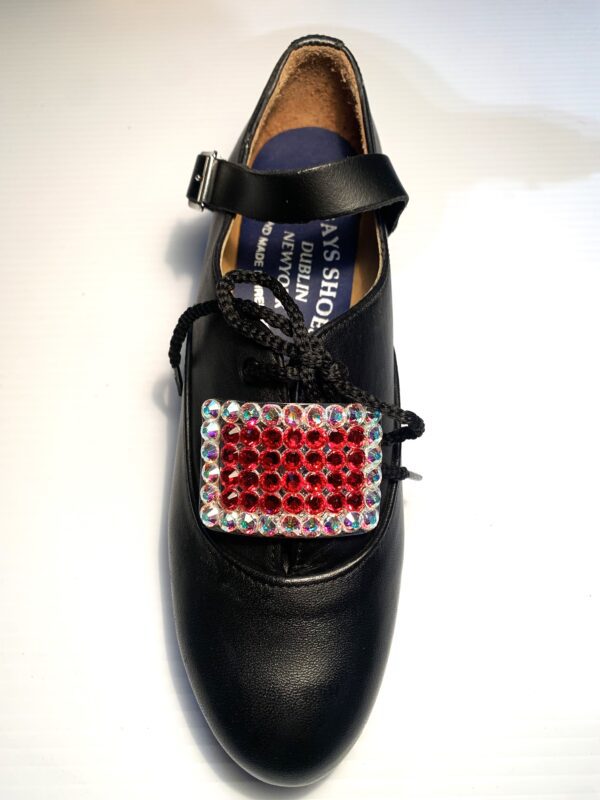 A black shoe with a Red and AB Crystals Buckles.