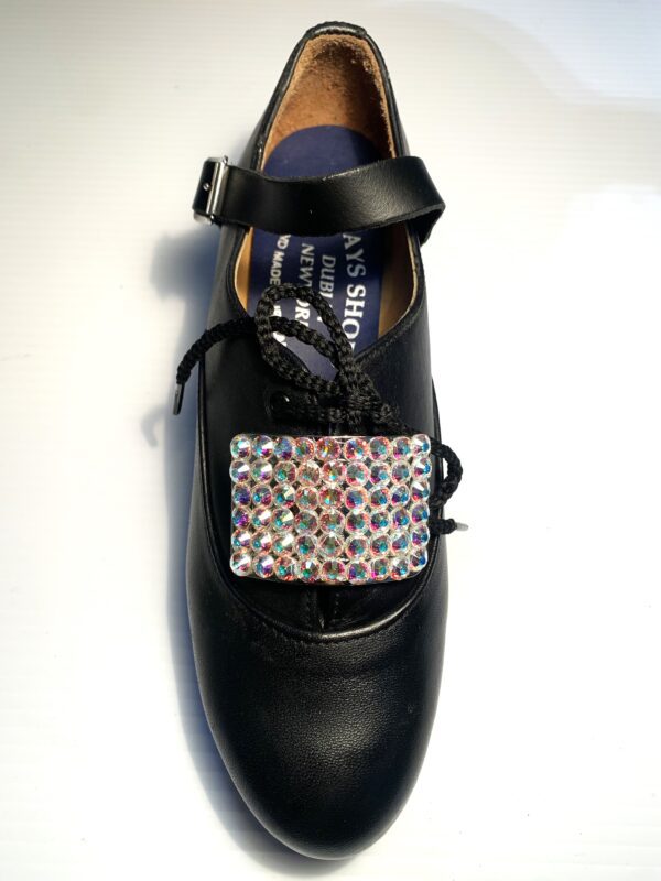 A black shoe with AB Crystal Buckles on it.