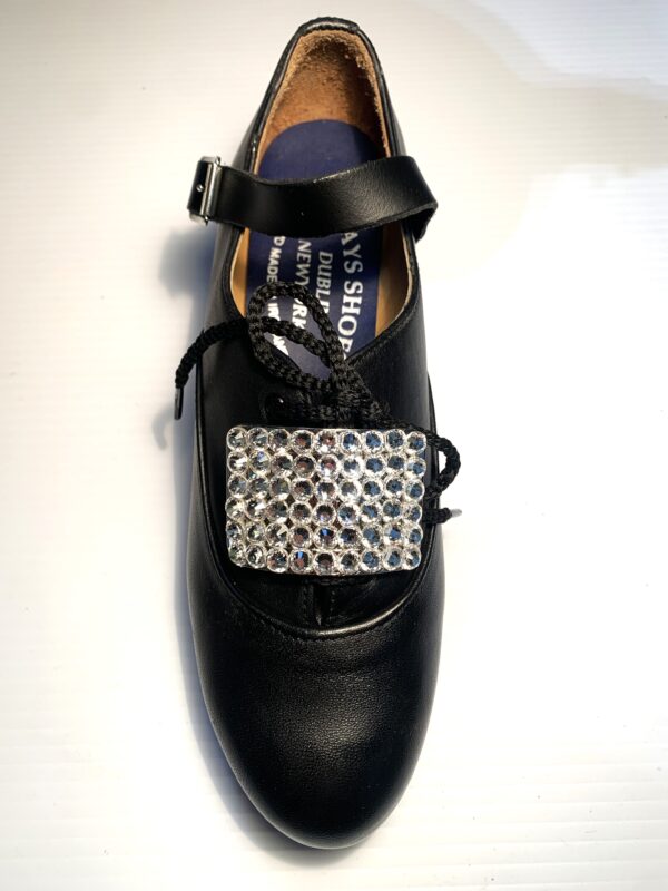 A pair of black shoes with Clear Crystal Buckles.